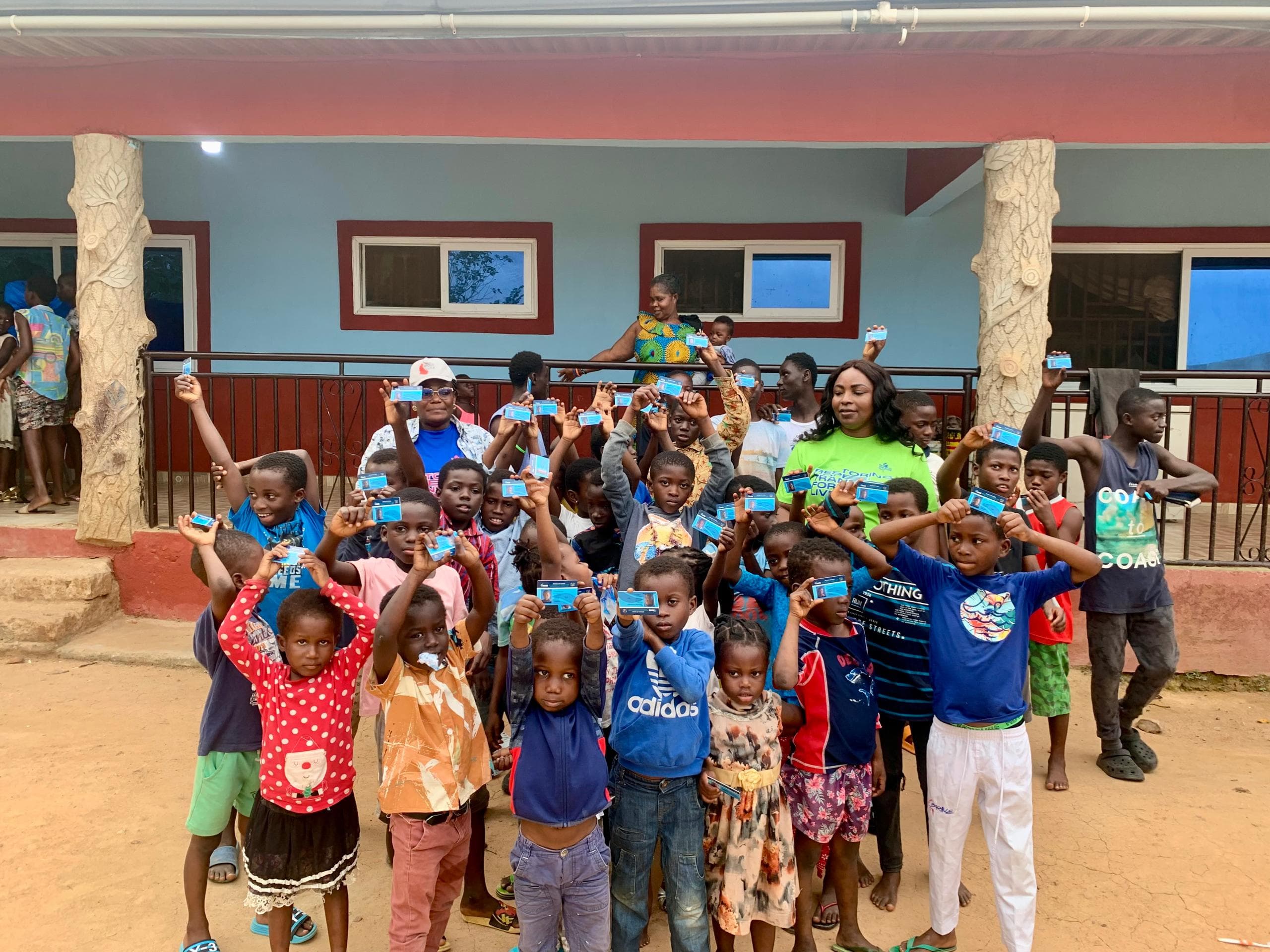 Children showing off their new National Health Insurance Scheme cards, provided by MaryMaud Foundation